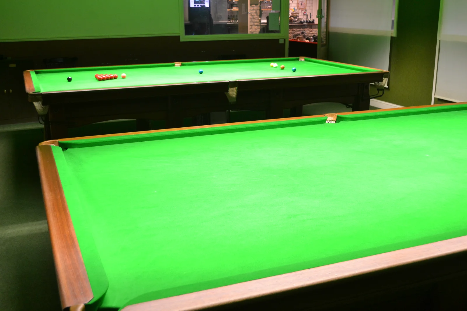 Two full-size snooker tables in the dedicated snooker room at Haydon Que Club